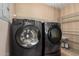 The laundry room is equipped with a washer, dryer and wire shelving for storage at 14000 N 94Th St # 3147, Scottsdale, AZ 85260
