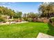 Spacious backyard with lush green grass, seating and shade, perfect for relaxing and entertaining at 15027 N 61St Pl, Scottsdale, AZ 85254