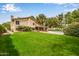 Lush green backyard featuring a spacious lawn and mature trees, perfect for outdoor activities at 15027 N 61St Pl, Scottsdale, AZ 85254