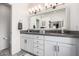 Bathroom features double sinks and granite countertops with white cabinets at 15027 N 61St Pl, Scottsdale, AZ 85254