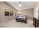 Bedroom with neutral colors, a ceiling fan, and two wall paintings at 15027 N 61St Pl, Scottsdale, AZ 85254