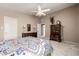 Cozy bedroom with neutral walls, ceiling fan and dresser set with decorative lamps and framed art at 15027 N 61St Pl, Scottsdale, AZ 85254