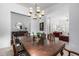 Elegant dining room with large table, decorative chandelier, and seamless access to living area at 15027 N 61St Pl, Scottsdale, AZ 85254