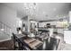 Open-concept dining room flows into a bright kitchen with stainless steel appliances and island seating at 15027 N 61St Pl, Scottsdale, AZ 85254