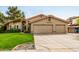 Beautiful home featuring a lush green lawn and a convenient three-car garage at 15027 N 61St Pl, Scottsdale, AZ 85254