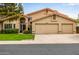 Well-maintained home with a spacious three-car garage and manicured lawn at 15027 N 61St Pl, Scottsdale, AZ 85254