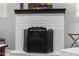 Detailed view of the white brick fireplace with decorative screen, adding charm and warmth at 15027 N 61St Pl, Scottsdale, AZ 85254