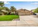 Charming single-Gathering home with well-manicured lawn and spacious three-car garage on a sunny day at 15027 N 61St Pl, Scottsdale, AZ 85254