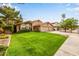 Inviting home exterior featuring a three-car garage and a well-maintained front lawn at 15027 N 61St Pl, Scottsdale, AZ 85254