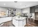 Bright open kitchen featuring a center island with marble countertop, and modern appliances at 15027 N 61St Pl, Scottsdale, AZ 85254