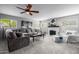 Spacious living room with a large sectional, brick fireplace, and bright natural light at 15027 N 61St Pl, Scottsdale, AZ 85254