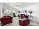 Bright living room with bay window, plush seating, ceiling fan, and neutral tones at 15027 N 61St Pl, Scottsdale, AZ 85254