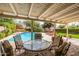 Outdoor patio with pool view, covered seating area, patio furniture and lush landscaping at 15027 N 61St Pl, Scottsdale, AZ 85254