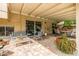 Covered patio with brick flooring, seating and dining areas, garden view and a glimpse of the pool at 15027 N 61St Pl, Scottsdale, AZ 85254
