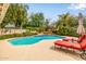 Inviting pool with sun loungers, lush landscaping and tranquil backyard setting at 15027 N 61St Pl, Scottsdale, AZ 85254