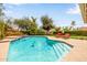 Inviting pool with lounge chairs and lush landscaping creates a backyard oasis at 15027 N 61St Pl, Scottsdale, AZ 85254