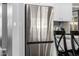 Close up of stainless steel four door refrigerator in kitchen with white cabinets at 15027 N 61St Pl, Scottsdale, AZ 85254