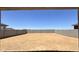 Large backyard featuring a block fence and a dirt landscape, ready for customization at 15784 W Beryl Ave, Waddell, AZ 85355