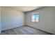 Minimalist bedroom with a neutral color scheme and a window providing natural light at 15784 W Beryl Ave, Waddell, AZ 85355