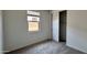 Comfortable bedroom with carpet, window, and closet featuring sliding doors at 15784 W Beryl Ave, Waddell, AZ 85355