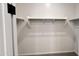 Walk-in closet featuring built-in shelving for optimal storage and organization at 15784 W Beryl Ave, Waddell, AZ 85355