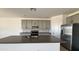 Stylish kitchen featuring gray cabinets, a center island, stainless steel appliances, and granite countertops at 15784 W Beryl Ave, Waddell, AZ 85355