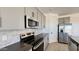 A well-equipped kitchen with stainless steel appliances, a stylish backsplash, and sleek countertops at 15784 W Beryl Ave, Waddell, AZ 85355