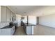 Bright kitchen featuring stainless steel appliances, gray cabinets, and an island with bar seating at 15784 W Beryl Ave, Waddell, AZ 85355