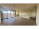 Spacious living room with tile flooring, sliding glass doors, and natural light at 15784 W Beryl Ave, Waddell, AZ 85355