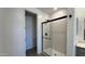 Modern glass-enclosed shower with black hardware in a bright bathroom at 15784 W Beryl Ave, Waddell, AZ 85355