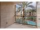 Balcony view of palm trees and community pool and the buildings at 1701 E Colter St # 311, Phoenix, AZ 85016