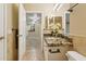 A light filled bathroom featuring granite counters and a white vanity at 1701 E Colter St # 311, Phoenix, AZ 85016