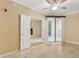 An airy bedroom with double doors, leading to another room and a balcony beyond at 1701 E Colter St # 311, Phoenix, AZ 85016