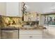 Kitchen sink with granite counters and a view of the living room, stainless steel dishwasher at 1701 E Colter St # 311, Phoenix, AZ 85016