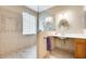Accessible bathroom showcasing roll-under sink, glass block window, and tiled shower at 18360 N 169Th Ave, Surprise, AZ 85374