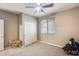 Cozy bedroom with carpet, ceiling fan, window, closet, and play table at 18360 N 169Th Ave, Surprise, AZ 85374