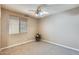 This carpeted bedroom features a window with blinds and ceiling fan at 18360 N 169Th Ave, Surprise, AZ 85374