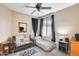 This bedroom is a comfortable retreat with a bed, couch and large window for natural light at 18360 N 169Th Ave, Surprise, AZ 85374