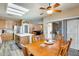 Open dining area featuring wood table, skylight, ceiling fan, and sliding glass door to the patio at 18360 N 169Th Ave, Surprise, AZ 85374