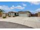 Single-story home with a three car garage, desert landscaping, and a long driveway at 18360 N 169Th Ave, Surprise, AZ 85374