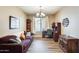 Comfortable home office/living room with natural light, a modern couch, and workspace at 18360 N 169Th Ave, Surprise, AZ 85374