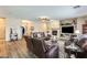 Cozy living room with wood floors, leather furniture, a fireplace, and a built-in entertainment center at 18360 N 169Th Ave, Surprise, AZ 85374