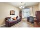 Home office featuring a purple sofa, desk, and large window providing natural light at 18360 N 169Th Ave, Surprise, AZ 85374