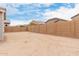 View of the backyard, featuring a blank slate with dirt lot surrounded by a tall block wall at 18988 W Cortez St, Surprise, AZ 85388