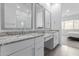 Well-lit bathroom with double vanity, granite countertops, and large mirrors at 18988 W Cortez St, Surprise, AZ 85388