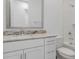 Bathroom with white vanity, granite countertop, neutral mirror frame, and shower/tub combo at 18988 W Cortez St, Surprise, AZ 85388