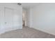 Bedroom with beige carpet, white walls, white trim, closet and door at 18988 W Cortez St, Surprise, AZ 85388