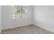 Bright bedroom featuring neutral carpet, crisp white walls, and natural light at 18988 W Cortez St, Surprise, AZ 85388