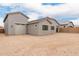 Single-story home with light stucco, neutral trim, garage, and large dirt lot surrounded by block wall at 18988 W Cortez St, Surprise, AZ 85388