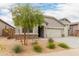 Charming single-story home featuring a three car garage, desert landscaping, and a stone facade at 18988 W Cortez St, Surprise, AZ 85388